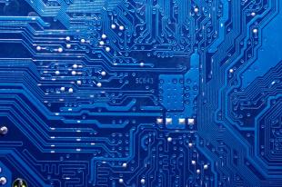 Close up photogaph of a blue circuit board used in bioelectronics