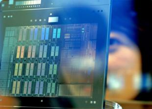 A lady holding futuristic glass screen computing device in front of her face