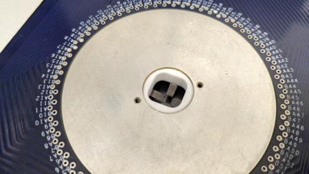 Blue probe card with a silver circle in the middle